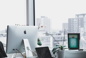 A laptop and computer on top of a desk.